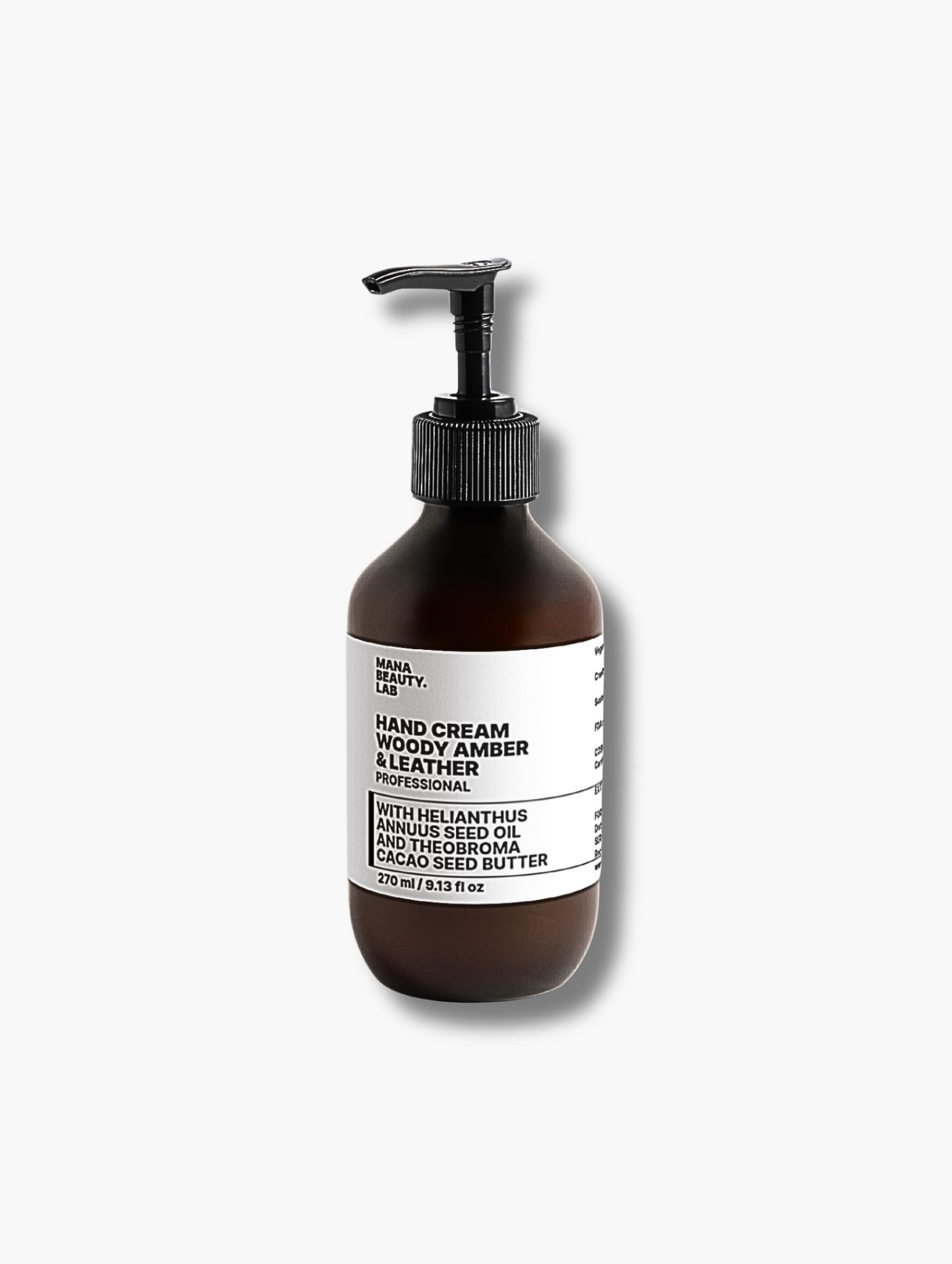 Woody amber and leather hand cream by MANA BEAUTY.LAB in dark glass pump bottle